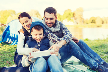 Image showing happy family with tablet pc and tent at camp site