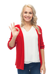 Image showing happy smiling young woman showing ok hand sign