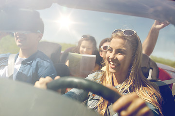 Image showing happy friends driving in cabriolet car