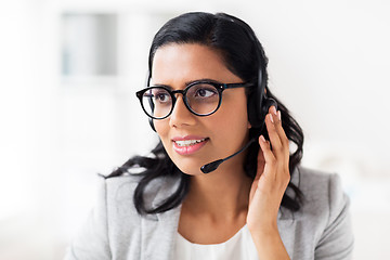 Image showing businesswoman with headset talking at office