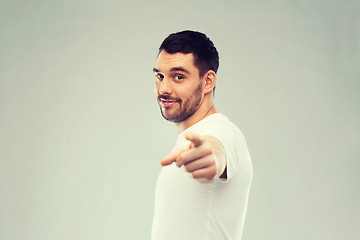 Image showing man pointing finger to you over gray background