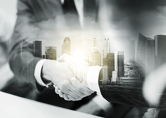 Image showing two businessmen shaking hands at office