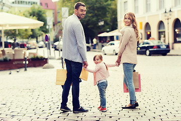 Image showing happy family with child and shopping bags in city