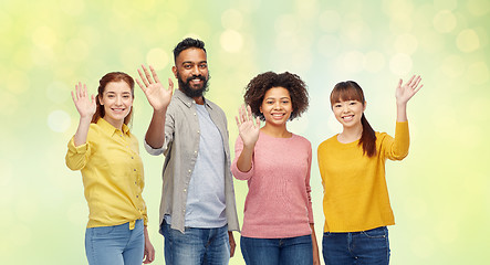 Image showing international group of happy people waving hands