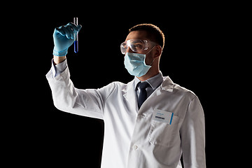 Image showing scientist with safety glasses, mask and test tube