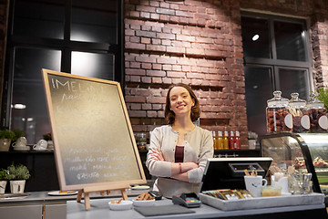 Image showing happy woman or barmaid at cafe counter