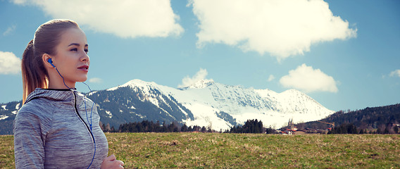 Image showing happy woman with earphones running