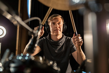 Image showing male musician playing drums and cymbals at concert