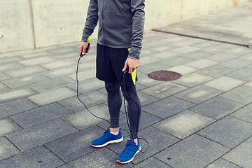 Image showing close up of man exercising with jump-rope outdoors