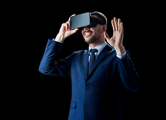 Image showing businessman in virtual reality headset over black