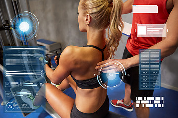 Image showing man and woman flexing muscles on gym machine