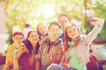 Image showing happy teenage students taking selfie by smartphone