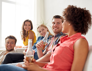 Image showing happy friends with popcorn and beer at home