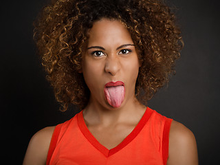 Image showing Beautiful woman pulling her tongue out