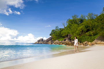 Image showing A beautiful woman walking on the beach