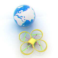 Image showing Quadrocopter Drone with Earth Globe and remote controller on a w