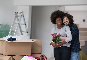 Image showing multiethnic couple moving into a new home