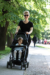 Image showing mother pushed her baby daughter in a stroller