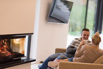 Image showing Young couple  in front of fireplace