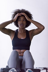 Image showing black woman doing sit ups at the gym