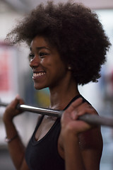 Image showing black woman lifting empty bar