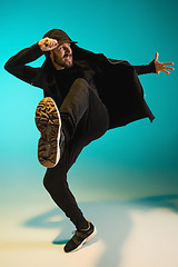 Image showing The silhouette of one hip hop male break dancer dancing on colorful background