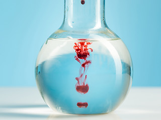 Image showing The laboratory glassware and red liquid inside on white