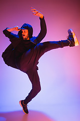 Image showing The silhouette of one hip hop male break dancer dancing on colorful background