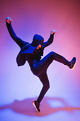 Image showing The silhouette of one hip hop male break dancer dancing on colorful background