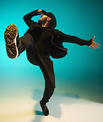 Image showing The silhouette of one hip hop male break dancer dancing on colorful background