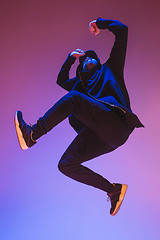 Image showing The silhouette of one hip hop male break dancer dancing on colorful background