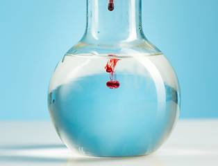 Image showing The laboratory glassware and red liquid inside on white