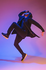 Image showing The silhouette of one hip hop male break dancer dancing on colorful background