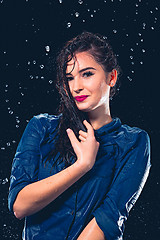 Image showing Young beautiful woman under splash of rain