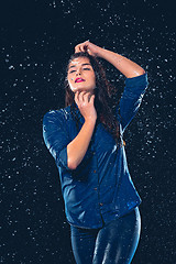 Image showing Young beautiful woman under splash of rain