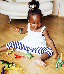 Image showing little cute african american girl playing with animal toys at ho