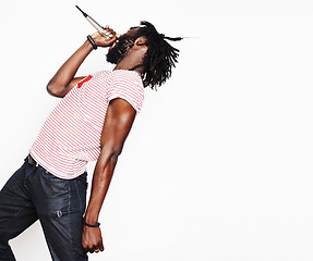 Image showing young handsome african american boy singing emotional with microphone isolated on white background, in motion gesturing 