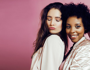Image showing different nation girls with diversuty in skin, hair. Asian, scandinavian, african american cheerful emotional posing on pink background, woman day celebration, lifestyle people concept 