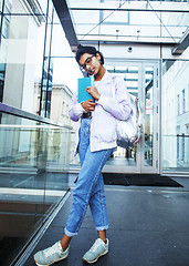 Image showing young cute indian girl at university building sitting on stairs 