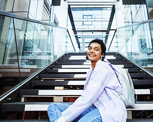 Image showing young cute indian girl at university building sitting on stairs 