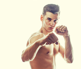 Image showing young handsome naked torso man boxing on white background isolated, lifestyle sport agressive people concept