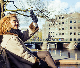 Image showing young cute blond african american girl student holding tablet and smiling, lifestyle people concept 