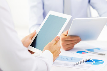 Image showing businesswomen with tablet pc and charts at office