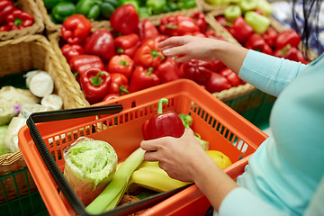 Image showing woman with basket buying peppers at grocery store