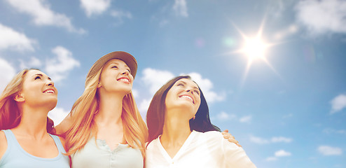 Image showing group of happy smiling women or friends over sky