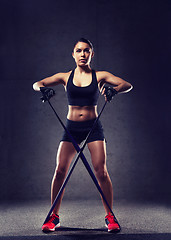 Image showing woman with expander exercising in gym