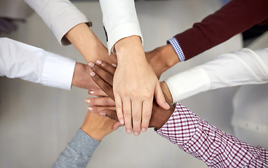 Image showing business team with hands on top at office