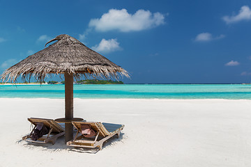 Image showing palapa and sunbeds on maldives beach