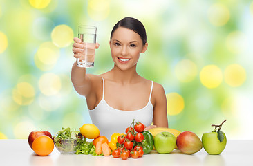 Image showing happy woman with glass of water and healthy food