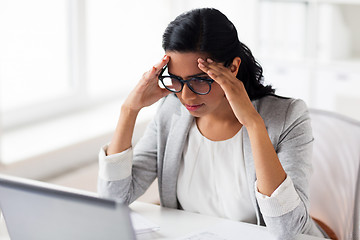 Image showing stressed businesswoman with laptop at office